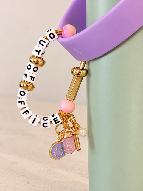 Out of Office letter-bead hook with pink beads, gold hardware and tiny colorful charms on a mint bag